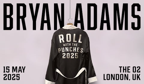 Promotional poster for Bryan Adams' "Roll With the Punches 2025" tour. A black satin boxing robe with silver lettering hangs on a hook, displaying the tour name. "Bryan Adams" is written in large, bold black letters in the background.